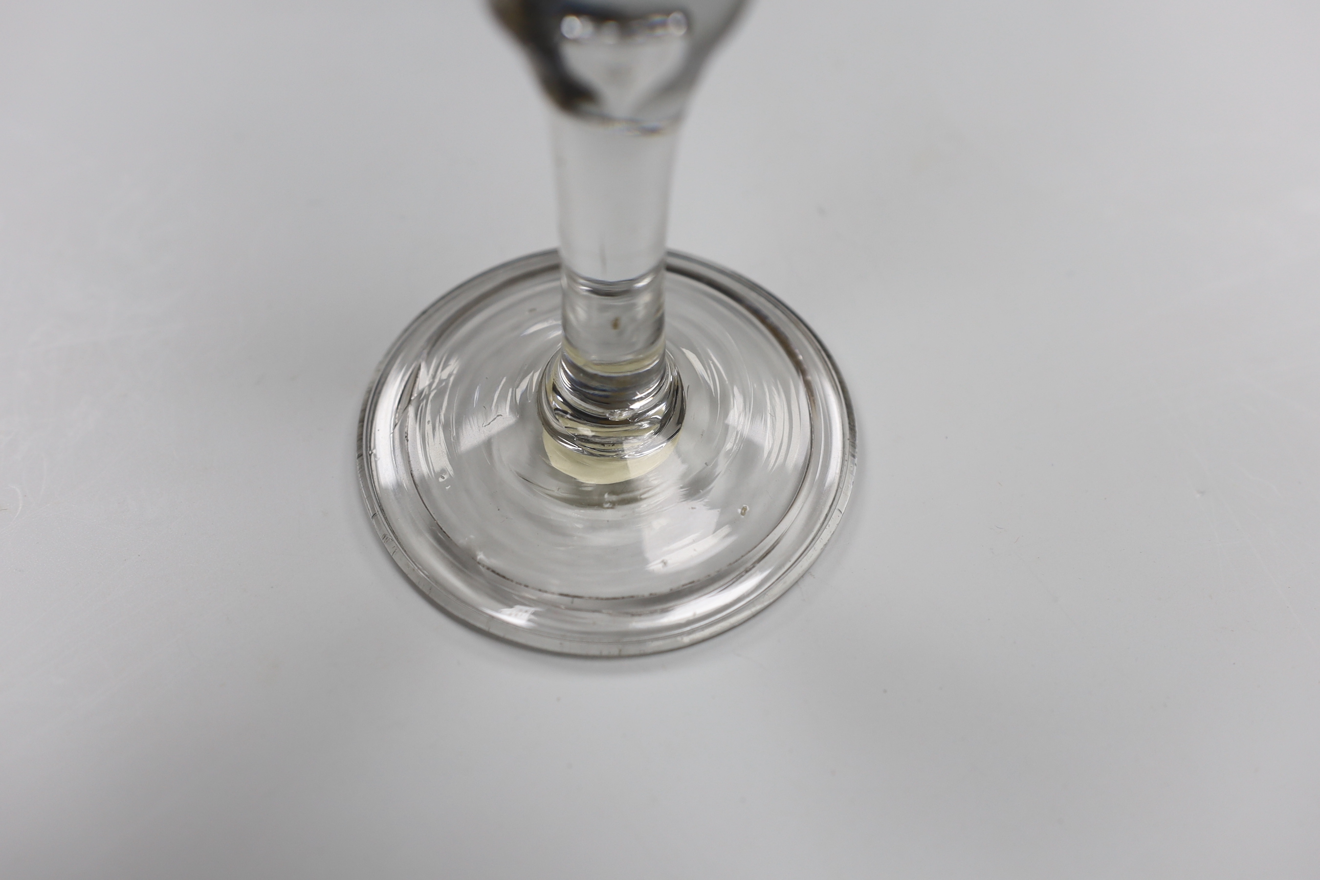 A George II wine glass, bell bowl with air-tear, folded foot, 16cm tall